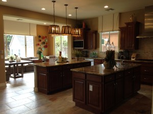 Model home kitchen with double islands and informal eating area