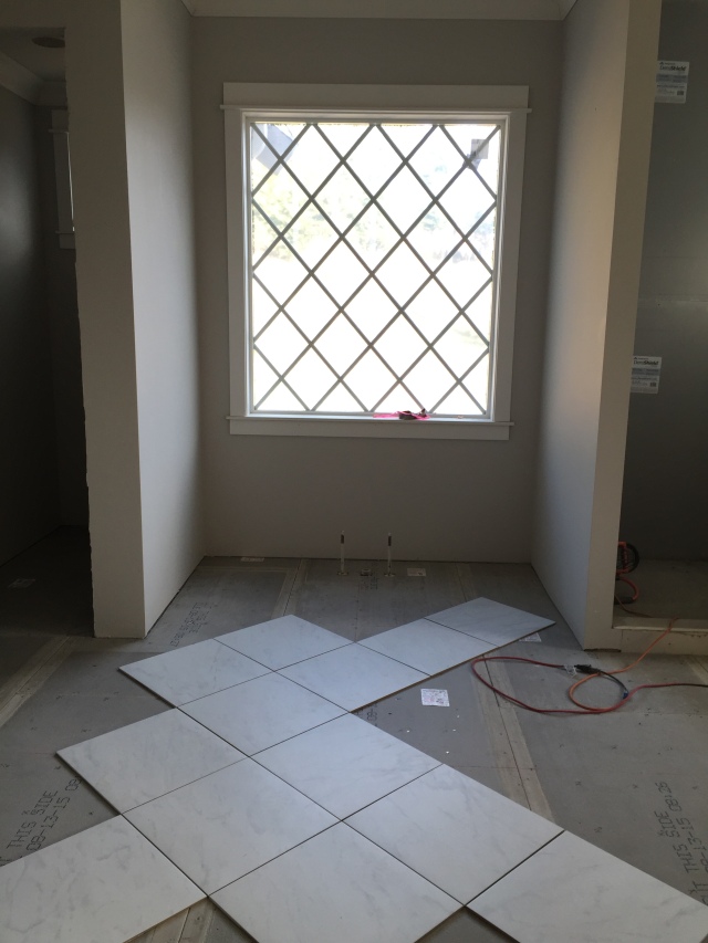 In the master bath we decided to turn the floor tiles "on point" which mimics the window grids.  This was just a dry run of it, but I have a hunch that it'll look great!  